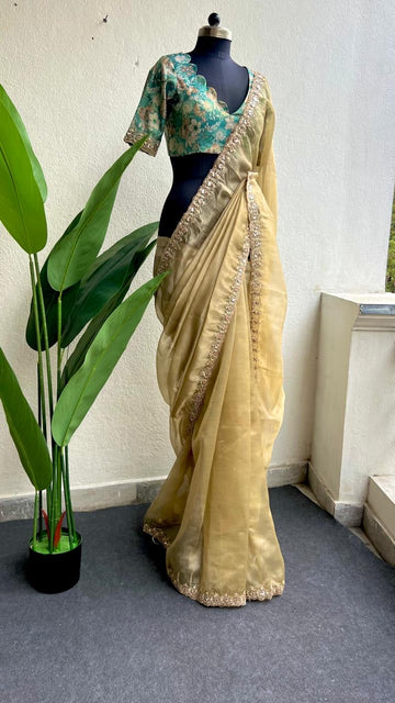 Golden soft tissue saree with blue floral embroidery blouse