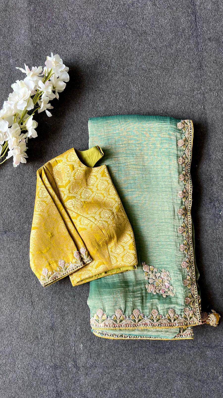 Light green soft tissue saree with golden banarasi blouse