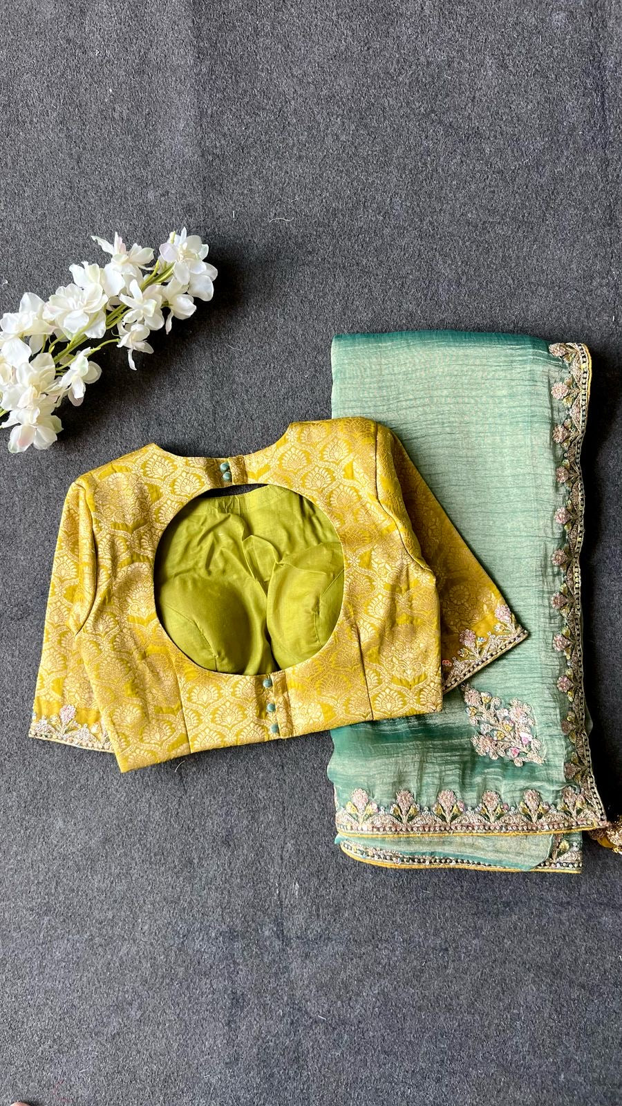 Light green soft tissue saree with golden banarasi blouse