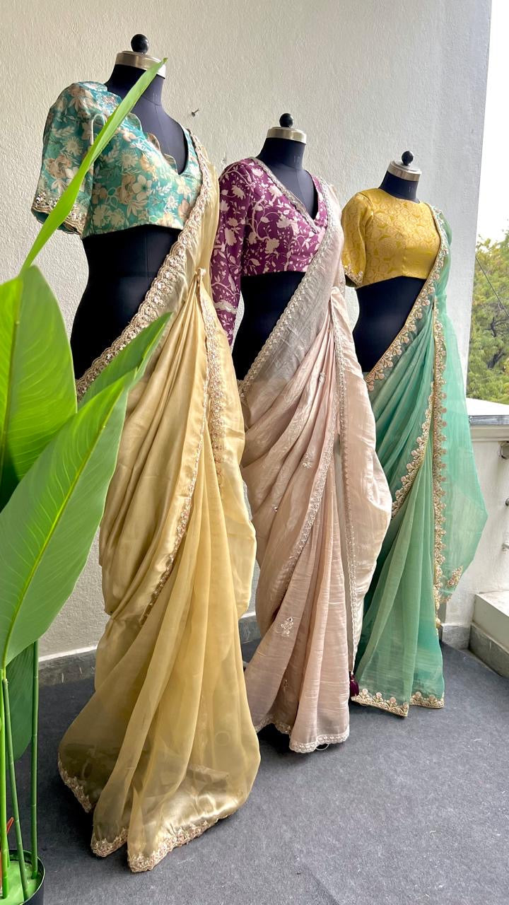 Light green soft tissue saree with golden banarasi blouse